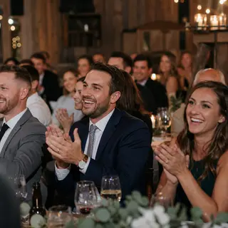 Guests cheering at a wedding toast